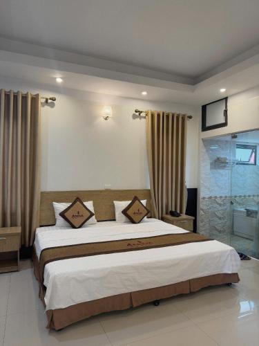 a bedroom with a large bed in a room at AVS Nội Bài Hotel in Sóc Sơn
