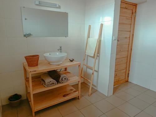 a bathroom with a sink and a mirror at Maison Hely Tiana in Antananarivo