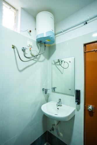 a bathroom with a sink and a mirror at Hotel Indiana Hitech City in Hyderabad