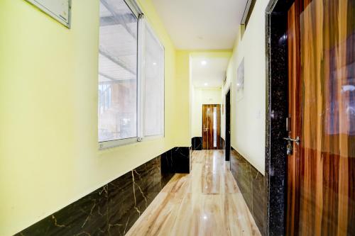 a hallway with a wooden floor and a window at SPOT ON Parampara Garden Resort in Shamsgarh