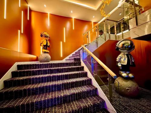 a set of stairs in a room with colorful walls at Palette Hi Hotel Bangkok in Makkasan