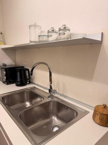 a kitchen counter with a sink in a kitchen at Rose e Frutta - Silver Moon in Monfalcone
