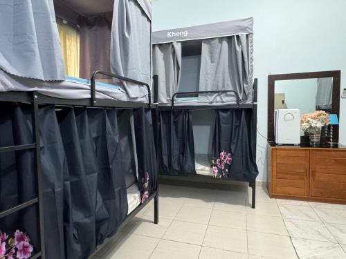 a bedroom with two bunk beds and a mirror at Bed space for Budget Backpacker - No Parking in Abu Dhabi