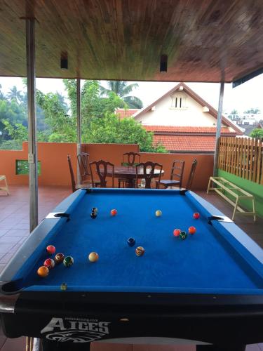 a pool table in the middle of a patio at Vongprachan Backpackers Hostel in Luang Prabang