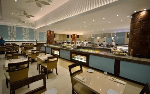 a restaurant with tables and chairs and a buffet at Henann Resort Alona Beach in Panglao