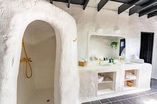 a bathroom with a white sink and a mirror at La Geria Suites in Yaiza