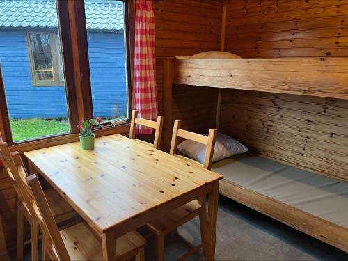 een eettafel en een stapelbed in een hut bij Camping Suderse - It Sweltsje in Workum