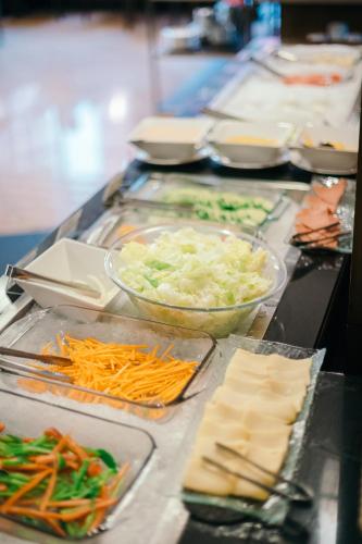 a buffet line with vegetables and other food items at City Garden Hotel Makati in Manila