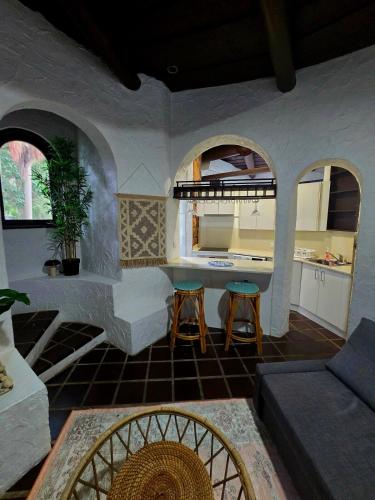 a living room with a couch and a table at Tropical Spanish Style Cabana - New Listing! in Sydney