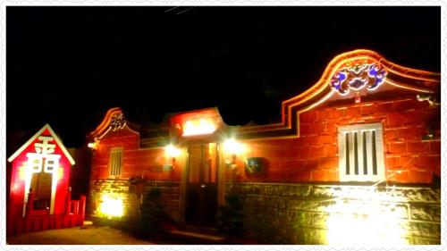 a house with red and white lights on it at 彼岸古厝民宿-包棟優先--Biiann B&B in Jinning