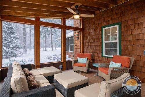 eine abgeschirmte Veranda mit Sofas und Stühlen in der Unterkunft Peaceful Lake Como Retreat in Lake Como