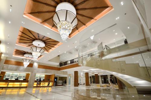 a large lobby with a staircase and chandeliers at Henann Resort Alona Beach in Panglao