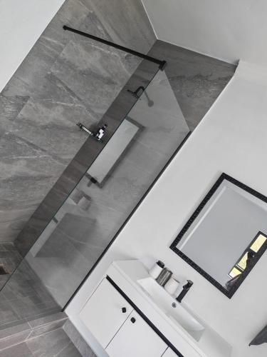 a bathroom with a mirror and a sink at Tee Off House - Parys Golf and Country Estate in Parys
