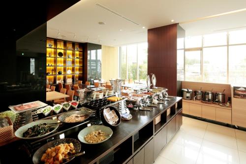 a buffet line with many different types of food at Candeo Hotels Chino in Chino