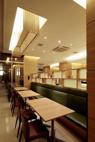 a row of tables and chairs in a restaurant at Candeo Hotels Shizuoka Shimada in Shimada