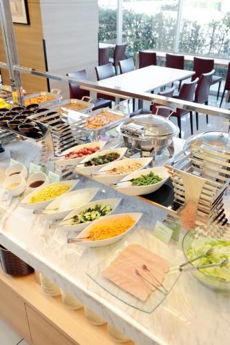a buffet with many plates of food on a table at Candeo Hotels Shizuoka Shimada in Shimada