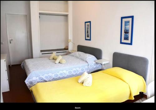 two beds sitting next to each other in a bedroom at Blife Mariangya private rooms at Faro beach in Faro