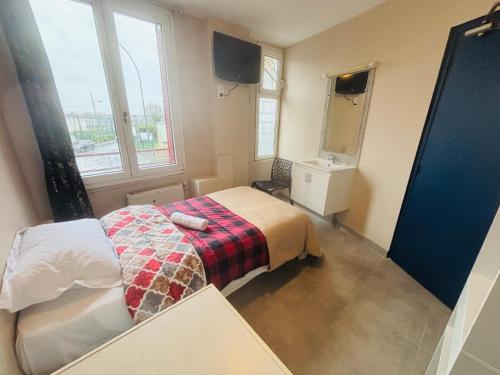 En eller flere senge i et værelse på Le Grand Café