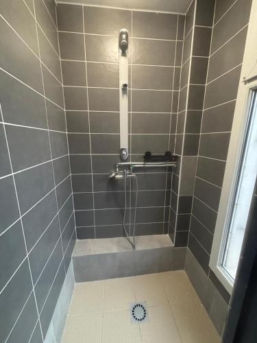 a bathroom with a shower with a shower at Le Grand Café in Châtillon