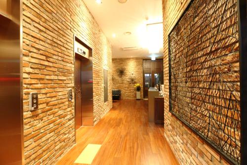 a hallway of a building with a brick wall at Bricks Hotel in Seoul