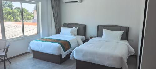 En eller flere senge i et værelse på Tongtong Garden Holiday Hotel普吉岛通通花园酒店