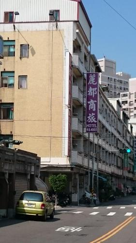 a car driving down a street next to a building at Rido Hotel in Taichung