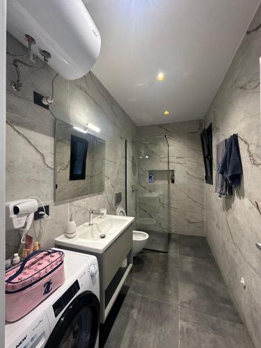 a bathroom with a sink and a toilet at ZEN Villa in Rrushkull