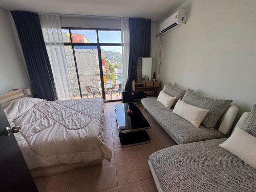 a living room with a bed and a couch at KataKeet in Kata Beach