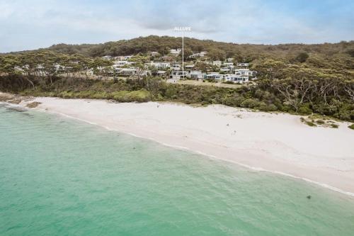 an aerial view of a beach with houses at Allure at Hyams Beach - seconds to white sands in Hyams Beach