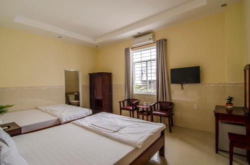 Säng eller sängar i ett rum på Kim Hồng Nhật Guest House