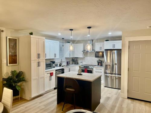 a kitchen with white cabinets and a island in it at Platinum Homes , Stylish 3BR Home,4 Min to YQM Airport, Sleeps 10 Free Parking in Dieppe