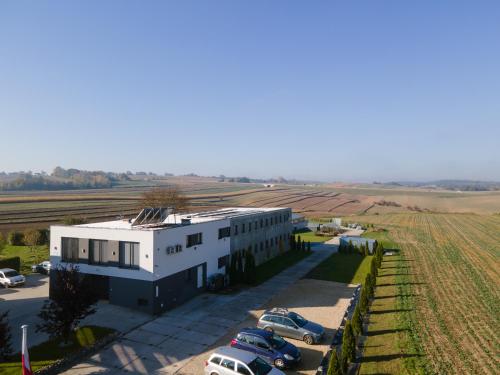 an aerial view of a building with cars parked in a parking lot at Kwatery Smroków in Smroków