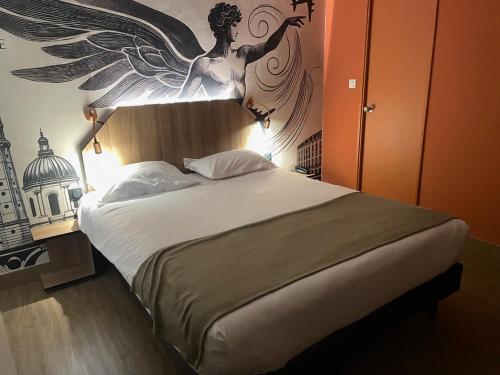 a bedroom with a bed with a angel above it at Hôtel Icare in Toulouse