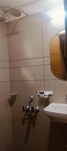 a bathroom with a sink and a mirror at Creek Harbour Fort Kochi in Fort Kochi