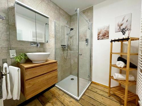 a bathroom with a sink and a shower at 'GoldPath' OldTown - Apartments Passau in Passau