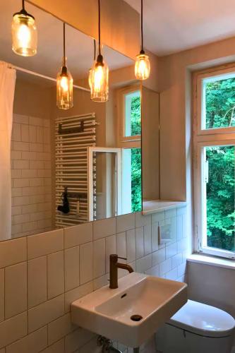 a bathroom with a sink and a mirror at VILLA AM SEE - nähe Berlin in Biesenthal