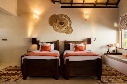 two twin beds in a room with at Shambhala in Bhopal