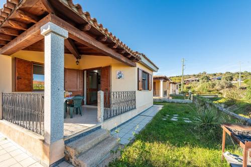 a house with a porch and a patio at AffittaSardegna - Appartamenti Appentos in Capo Comino