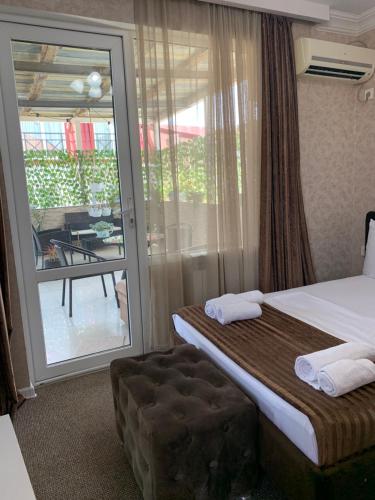 ein Hotelzimmer mit Bett und Balkon in der Unterkunft DavidL Inn - Avlabari in Tbilisi City