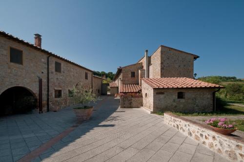 an alley in an italianastery with two stone buildings at Tenuta Decimo - Il Borgo Di Mariano in San Gimignano