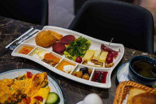 un vassoio di cibo su un tavolo con piatti di Byon Hotel Şile a Şile