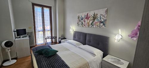 a bedroom with a large bed and a window at HOTEL RISTORANTE DELLE VALLI in Germagnano