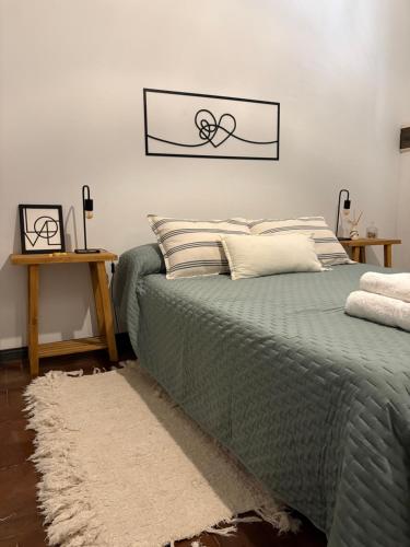 a bedroom with a green bed with a picture on the wall at Casa Soul in Chascomús