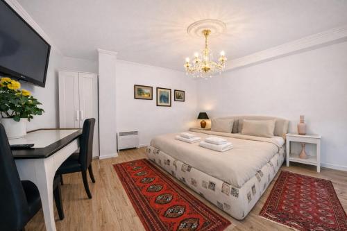 a bedroom with a bed and a desk and a computer at Garden Studio with Kitchen & BBQ - KindStay Suites Prague Airport in Kněžívka