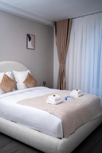 a bedroom with a large white bed with towels on it at Hôtel Sofiane in Paris