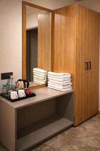 a pile of plates on a counter in a room at The Sky Comfort Hotel Mahi in Dwarka