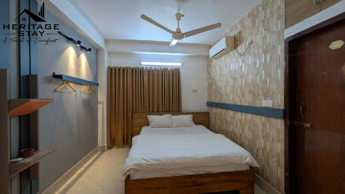 a bedroom with a bed and a ceiling fan at Heritage Stay Bagerhat in Bāgherhāt