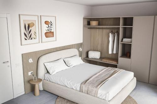 ein Schlafzimmer mit einem weißen Bett und einem Schrank in der Unterkunft Vibra Tahiti Comfort in Lido di Jesolo