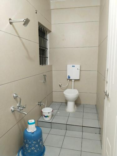 a bathroom with a toilet in a stall at Prestige Palace in Mugad