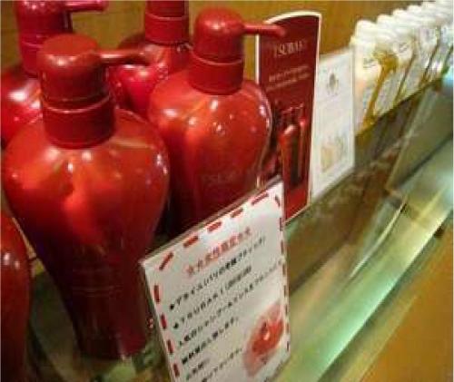 a group of red bottles on display in a store at Hotel Crown Hills Niigata in Niigata